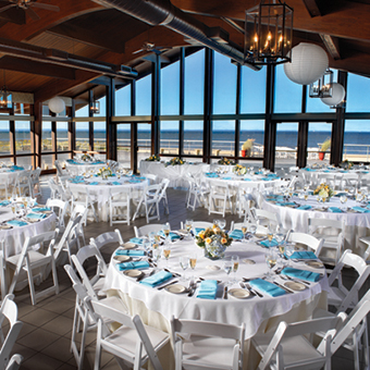 Blue and white themed reception setup with views of the ocean.
